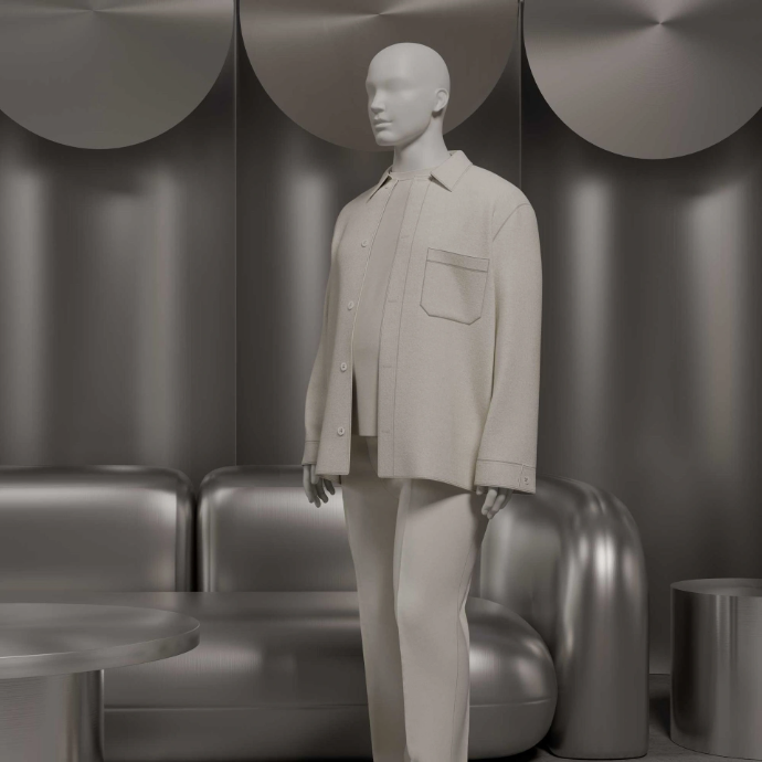 Abstract plus size male mannequin in an oversized beige overshirt and trousers standing in front of a metallic grey lounge sofa and curved wall panels