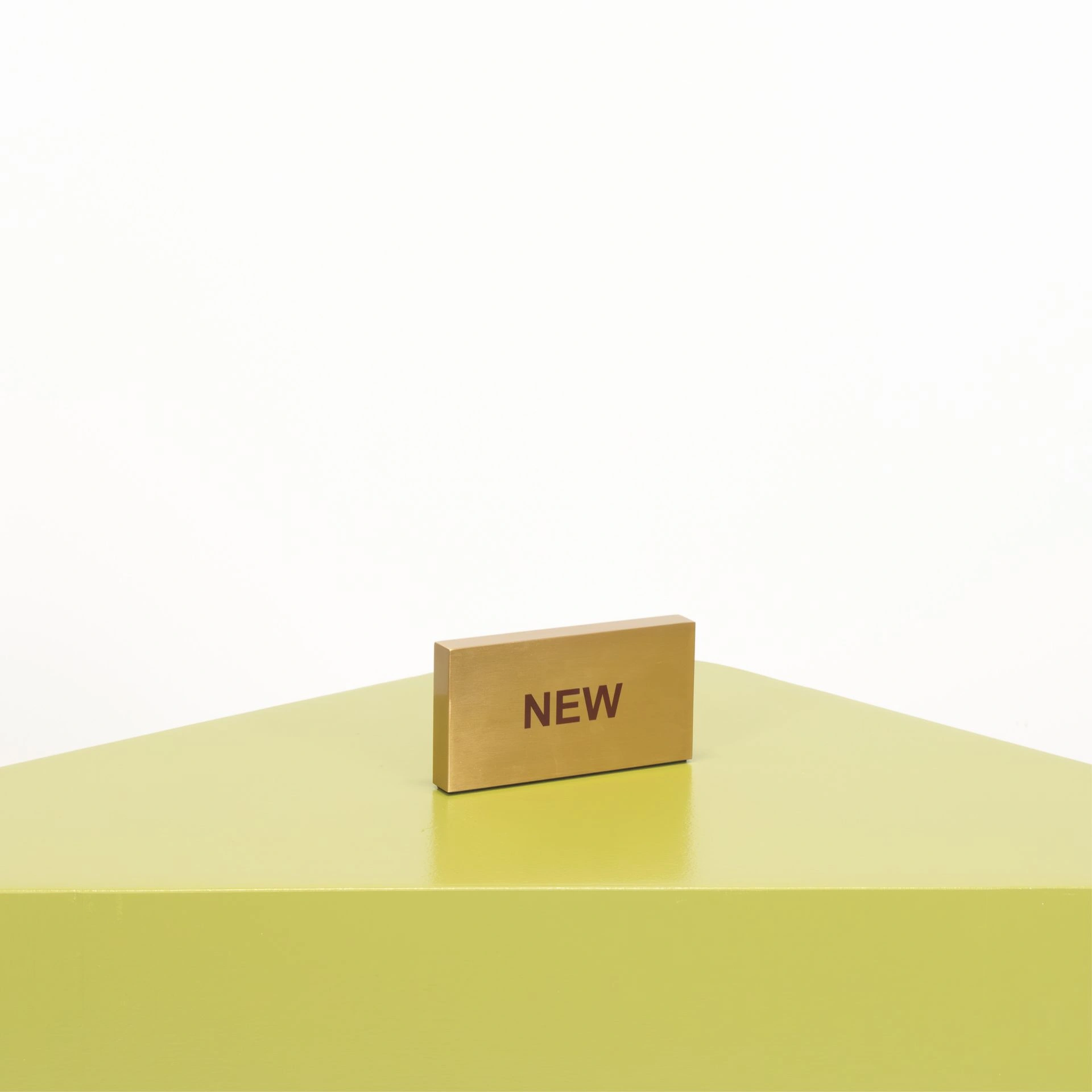 BINK - Presentation block "NEW", in brushed steel with gold finish